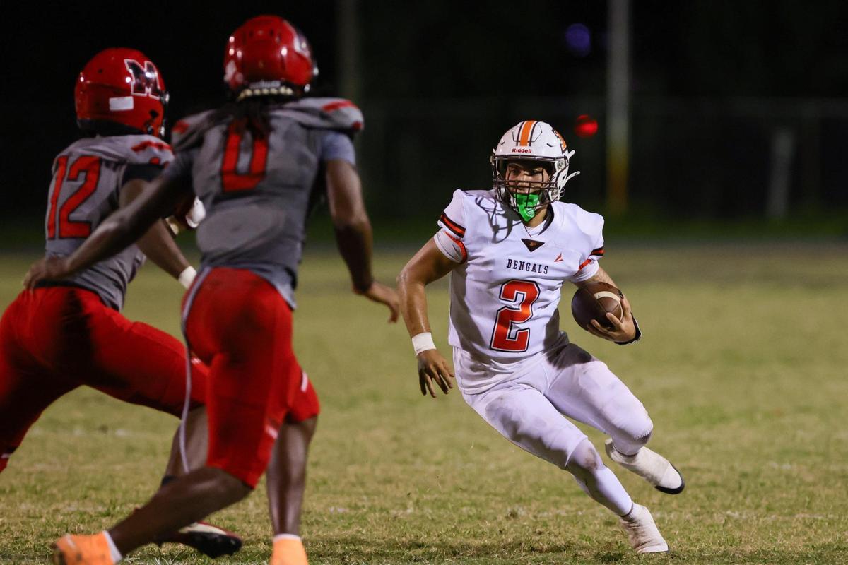 Piper Bengals quarterback Cristian Mata (2) runs with the football against the Monarch Knights during the second quarter of a high school football game at Don Conkel Stadium at Coconut Creek High School in Coconut Creek, Florida, Thursday, October 24, 2024.