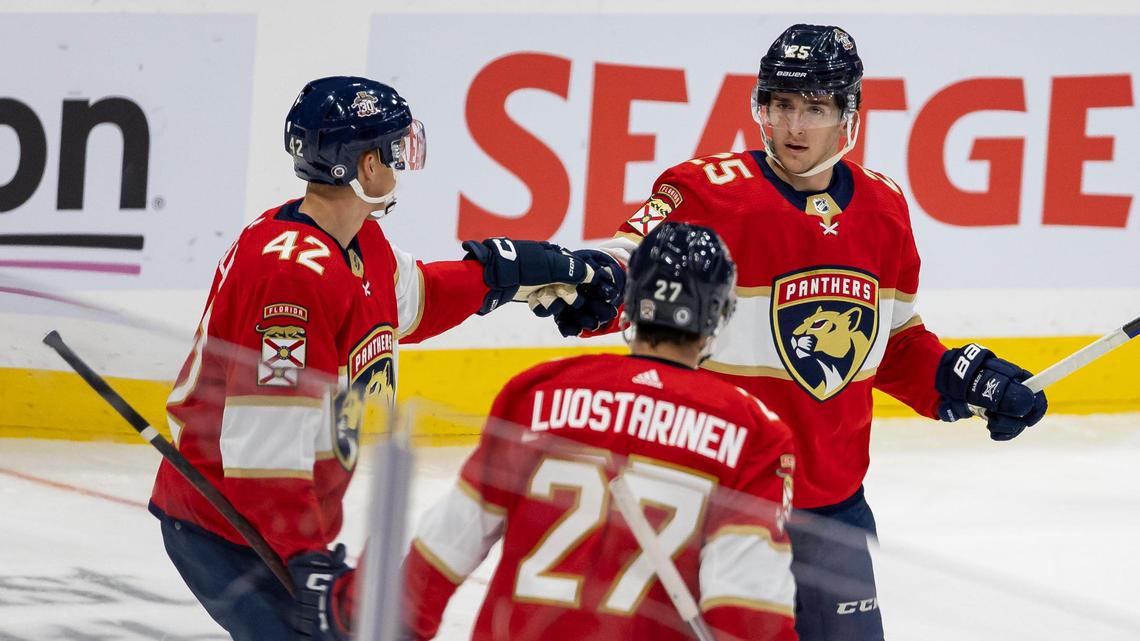 Florida Panthers forward Mackie Samoskevich (25) celebrates with defender Gustav Forsling (42) and forward Eetu Luostarinen (27) after scoring a goal against the Nashville Predators in the third period of an NHL preseason game at the Amerant Bank Arena on Monday, Sept. 25, 2023, in Sunrise, Fla.