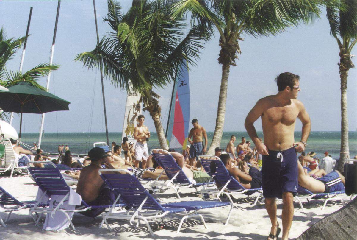 People soak up the sun in Key West on Smathers Beach.