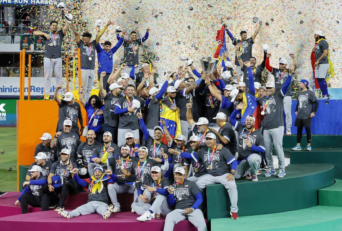 Venezuela players celebrate with the championship trophy after defeating the United States during the final game of the 2026 World Baseball Classic at loanDepot park on Tuesday, March 17, 2026. 
