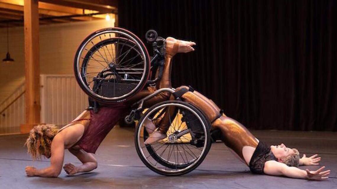 Kinetic Light dancer Laurel Lawson arches her back off the floor as Alice Sheppard, with her knees in Laurel’s footplate, crawls on her forearms, creating an optical illusion.