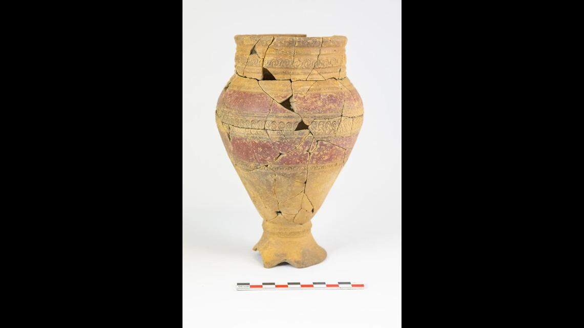 A vase found with cremated remains has both painted bands and punched patterns.