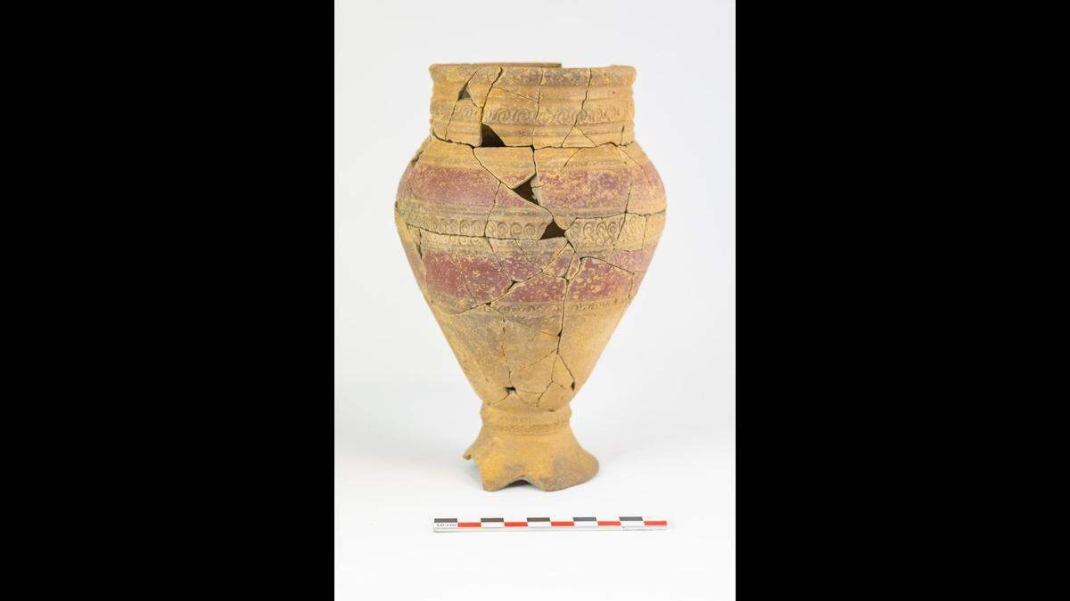 A vase found with cremated remains has both painted bands and punched patterns.
