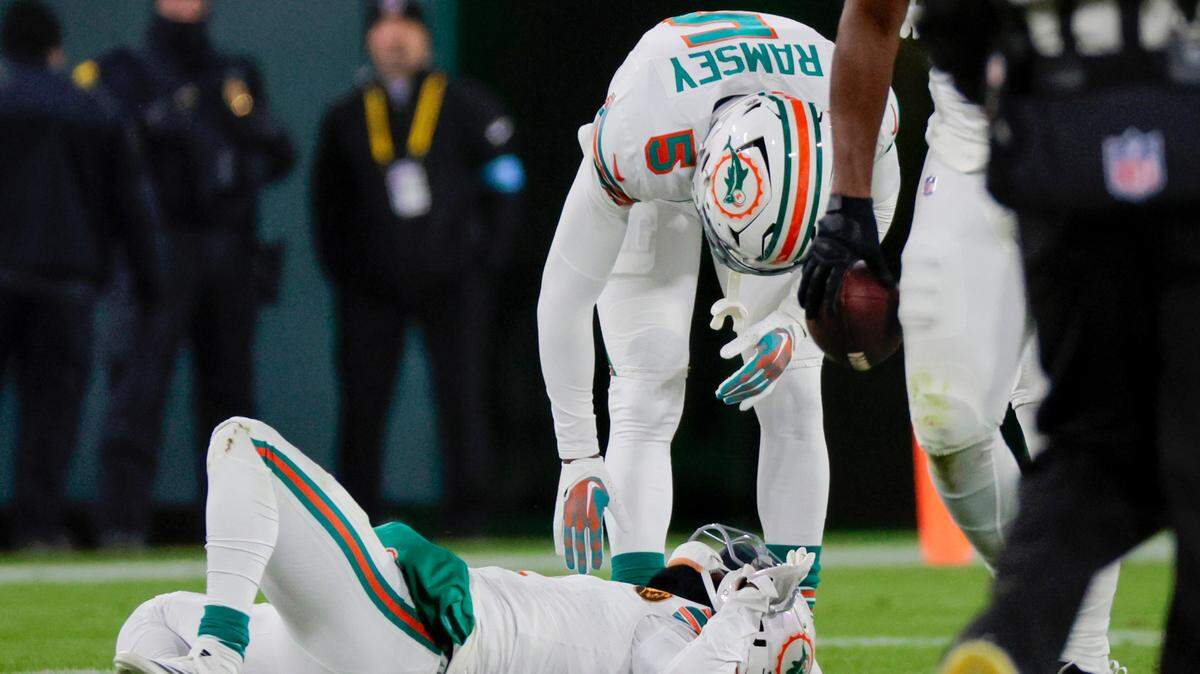 Miami Dolphins cornerback Jalen Ramsey (5) converses with teammate Kader Kohou (4) after Kohou sustained an injury during the first half of their NFL game against the Green Bay Packers at Lambeau Field in Green Bay, Wisconsin, on Thursday, November 28, 2024.