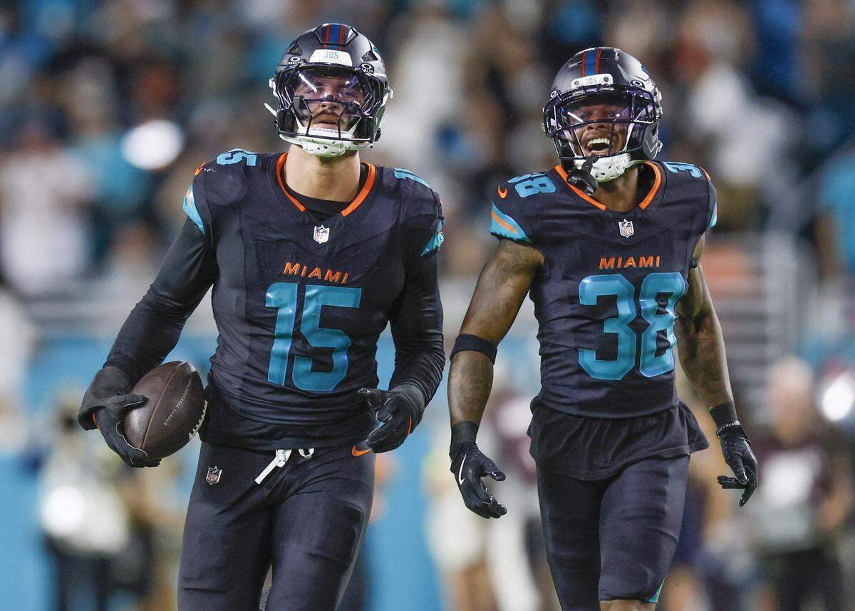 Miami Dolphins linebacker Jaelan Phillips (15) and Cornell Armstrong (38) celebrate after picking Phillips picks up a fumble against the New York Jets during their NFL game in the first half at Hard Rock Stadium in Miami Gardens, Florida, on Monday, September 29, 2025.