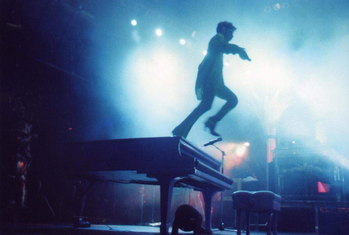 Prince in 1996 ‘jumping off his piano with gun looking mic,’ photographer Manny Hernandez writes in his new book, ‘Candids Miami.’