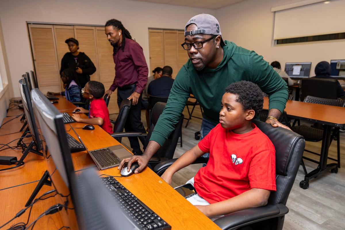 John Riley Jr., instructs Kemoni Rozier, 11, during a Next Gen Coders workshop sponsored by Miami Gardens’ Department of Educational Development at the Betty T. Ferguson Center.