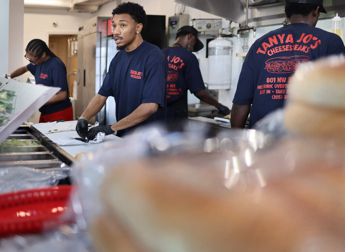 Miami native Siddiq Kancey, center, prepares cheesesteak sandwiches with his staff for the lunchtime rush on Thursday, Oct. 15, 2026.