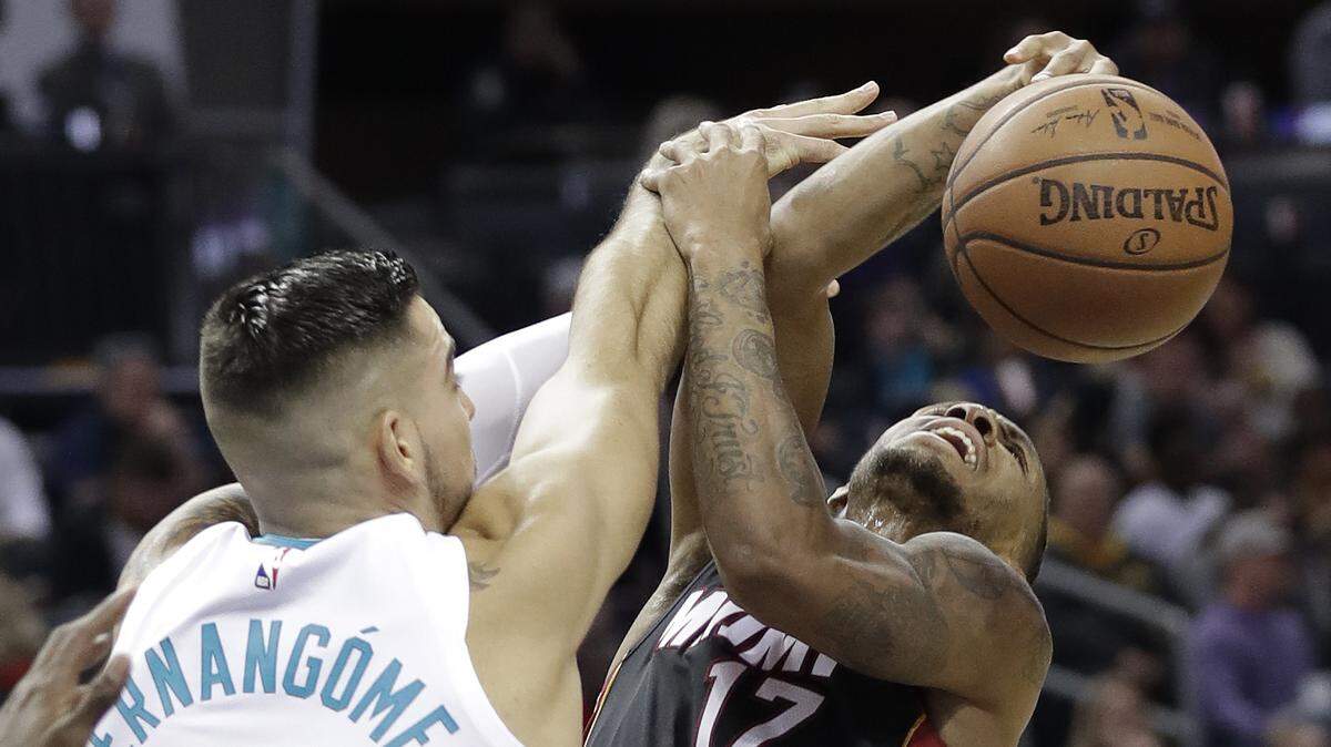 Charlotte Hornets’ Willy Hernangomez (41) blocks a shot by Miami Heat’s Rodney McGruder (17) in the second half of an NBA basketball game in Charlotte, N.C., Tuesday, Oct. 30, 2018.