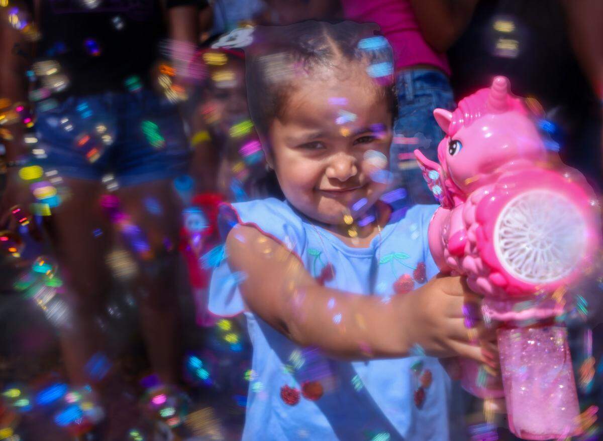 Destiny Arancivia, 3, showers friends and relatives with bubbles from her pink “My Little Pony” bubble machine at the Calle Ocho Festival on Sunday, March 9, 2025. The 2026 event is March 15, 2026.