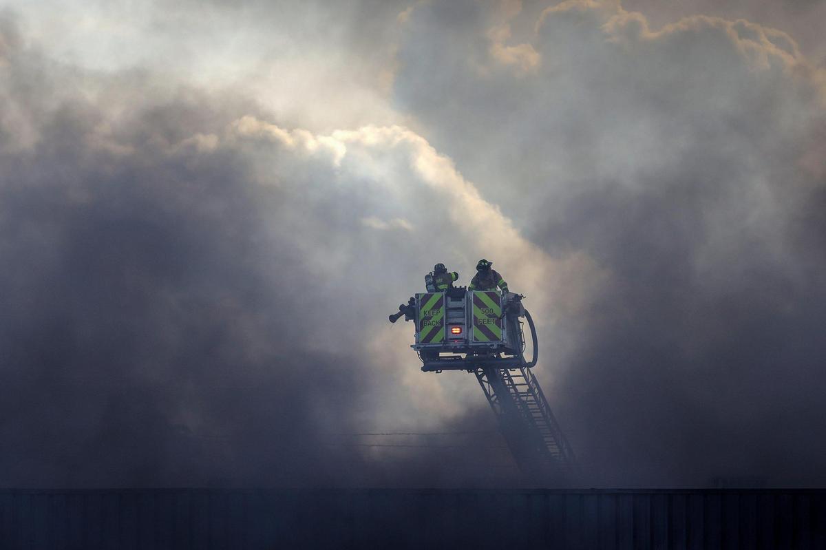 Miami-Dade firefighters battle a large fire at a flea market on Thursday, July 7, 2022, in Miami, Florida.
