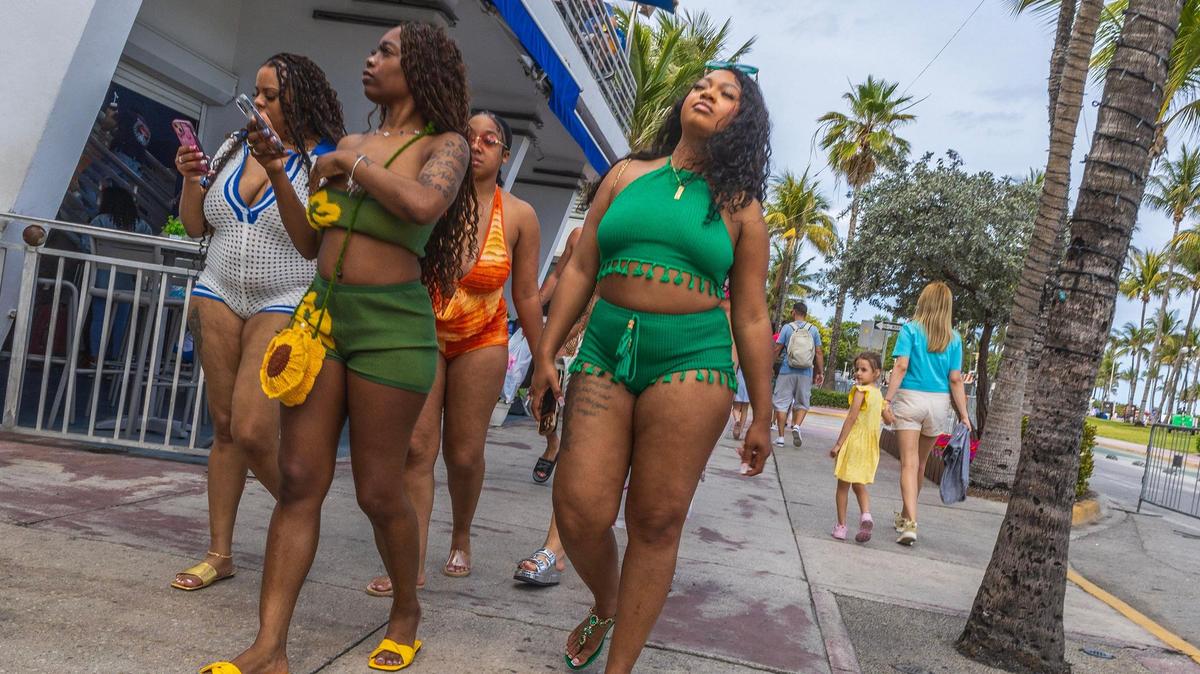 People make their way down Ocean Drive in South Beach during spring break in Miami Beach, Florida, on Saturday March 22, 2025.