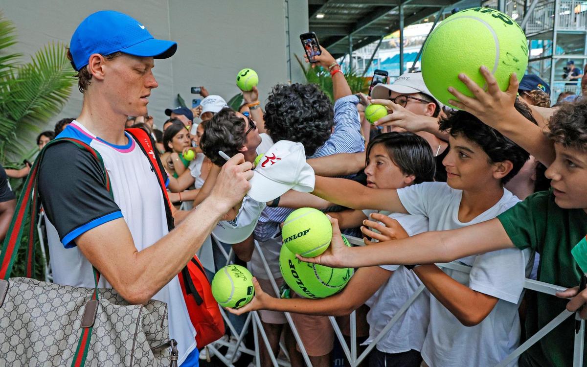Jannik Sinner of Italy autographs a hat for fans after defeating Tomas Machac of the Czech Republic during the Miami Open Tennis Tournament on Wednesday.
