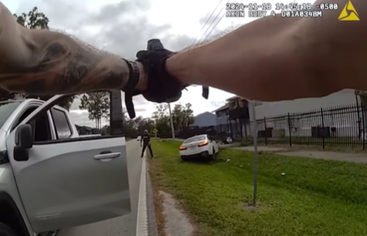 The suspect complied with police orders to surrender, video shows. He was charged with shooting into an occupied vehicle and aggravated assault with a deadly weapon, police said.