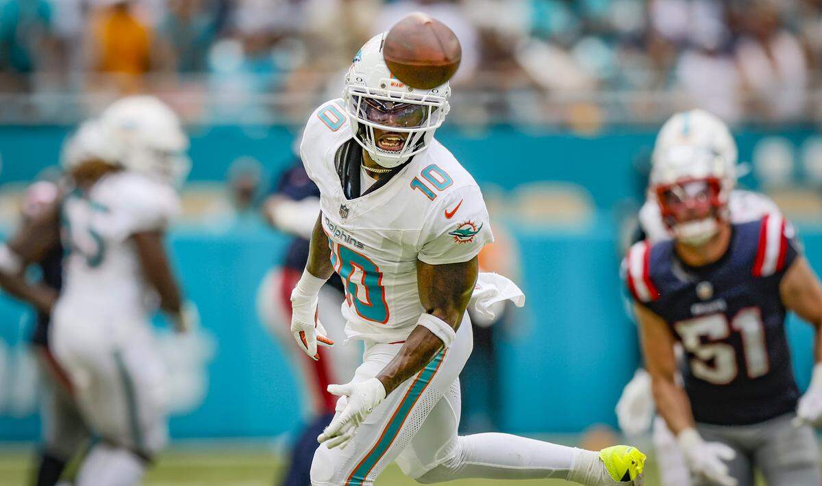 Miami Dolphins quarterback Tua Tagovailoa (1) overthrows wide receiver Tyreek Hill (10) in the second half against the New England Patriots during the NFL football game at Hard Rock Stadium in Miami Gardens, Florida, on Sunday, September 14, 2025.