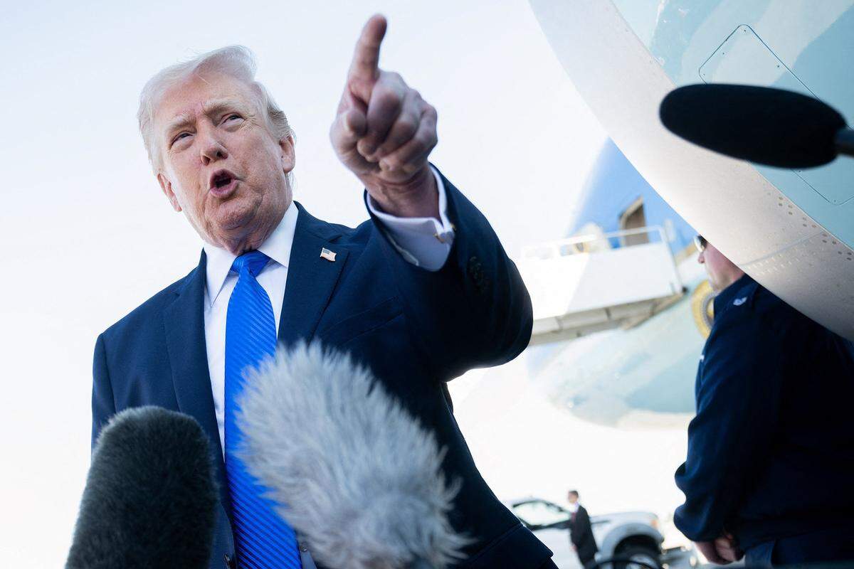 US President Donald Trump speaks to reporters before boarding Air Force One at Palm Beach International Airport in West Palm Beach, Florida, on March 23, 2026. (Saul Loeb/AFP via Getty Images/TNS)