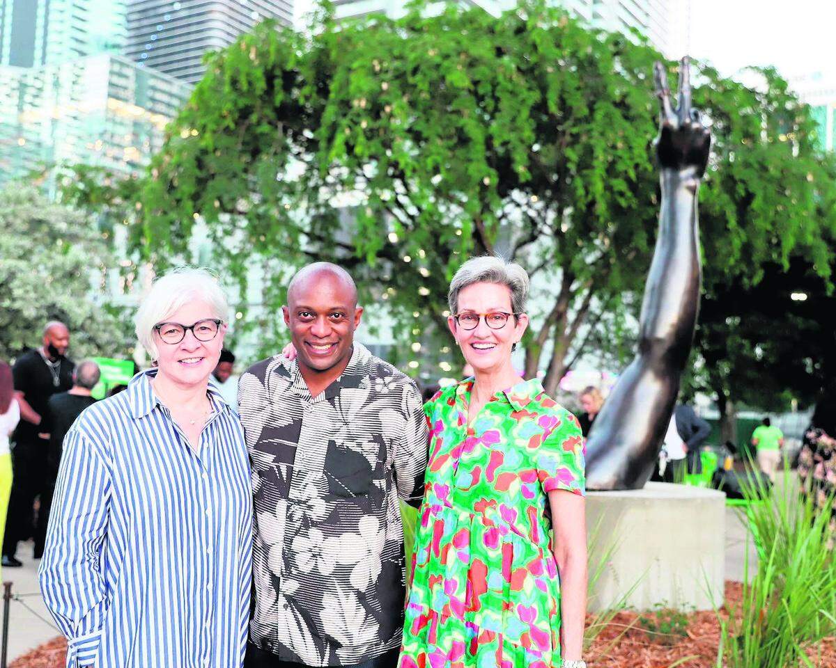 In this Underline photo from May 18, 2023, Knight Foundation vice president of arts Victoria Rogers (left), conceptual artist Hank Willis Thomas and The Underline originator Meg Daly are seen at the unveiling of “Duality” at its permanent home at The Underline. Thomas’ sculpture reflects how the same symbol can be interpreted in different ways.