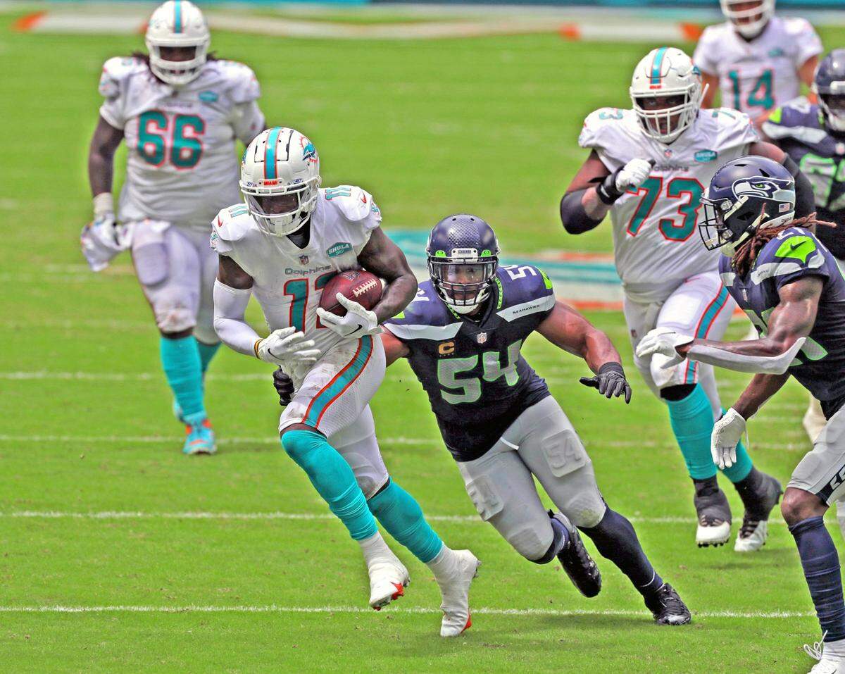 Miami Dolphins wide receiver DeVante Parker (11) on a reception in the first half as Seattle Seahawks middle linebacker Bobby Wagner (54) gives chase at Hard Rock Stadium in Miami Gardens on Sunday, October 4, 2020.