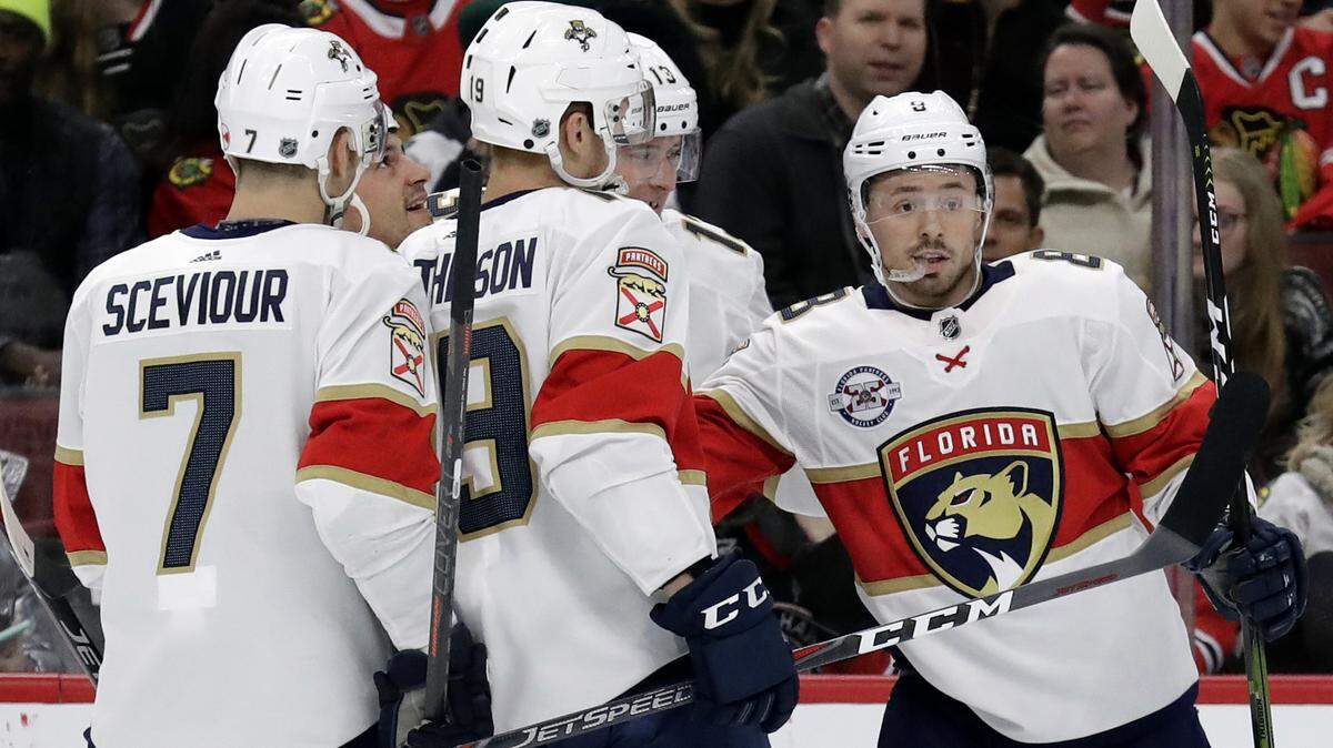 Florida Panthers center Jayce Hawryluk, right, celebrates with teammates after scoring his second goal against the Chicago Blackhawks during the second period of an NHL hockey game Sunday, Dec. 23, 2018, in Chicago. (AP Photo/Nam Y. Huh)