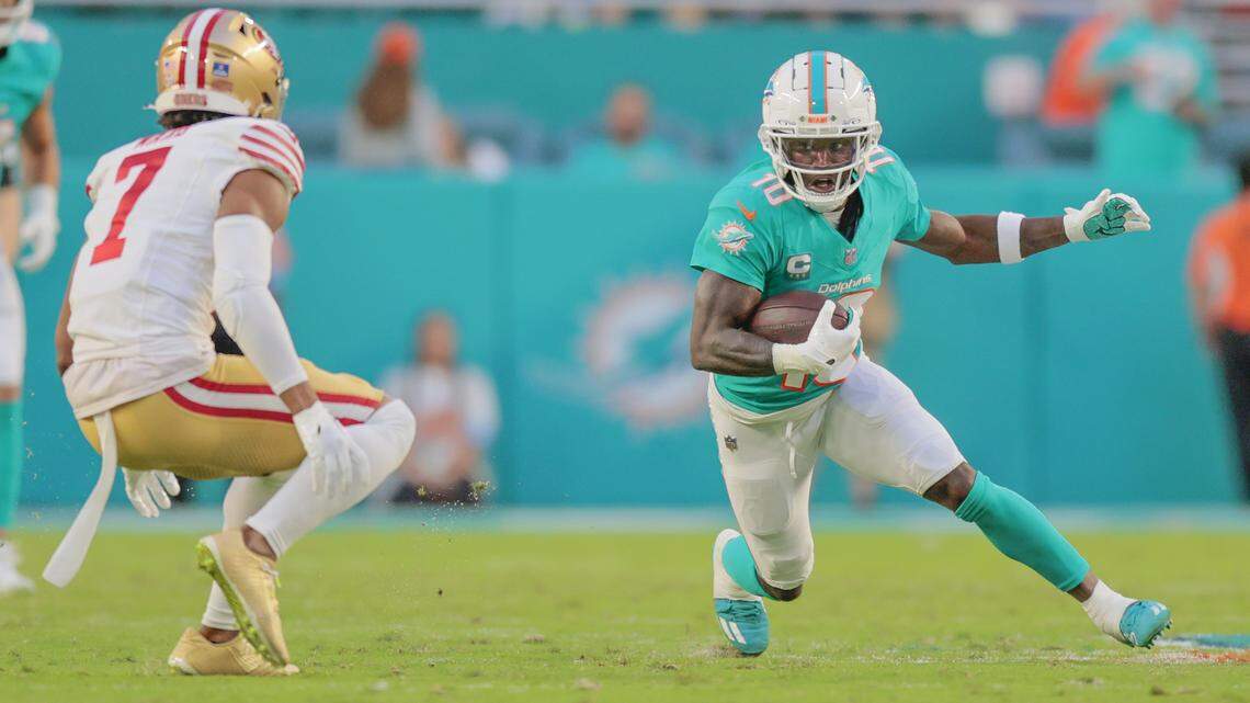 Miami Dolphins wide receiver Tyreek Hill (10) on a first down reception as San Francisco 49ers cornerback Charvarius Ward (7) attempts to make the stop during the first half of an NFL Football game at Hard Rock Stadium in Miami Gardens, Florida, on Sunday, December 22, 2024.