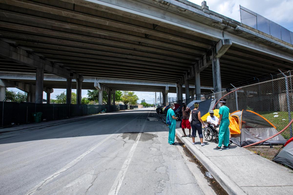 Volunteer medical providers screen and test homeless Miamians for the novel coronavirus underneath I-95 North in Overtown, Florida on Friday, April 24, 2020. Dr. Armen Henderson, Dream Defenders and coalition of community organizations and medical providers launched expanded services for the homeless in Overtown, including coronavirus testing for those without homes or regular access to health care.