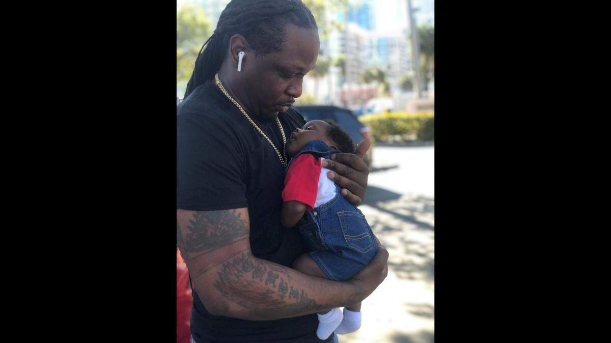 Thierry Bastien cradles his newborn baby in an undated photo.