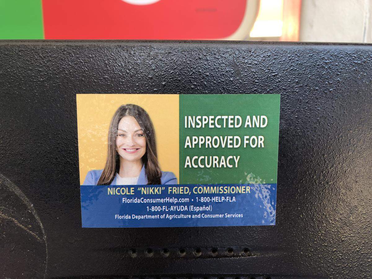 The new, colorful sticker includes a number to report fraud and the web address to a consumer portal, and replaces the traditional seal from administrations past — none of which had the face of the commissioner.