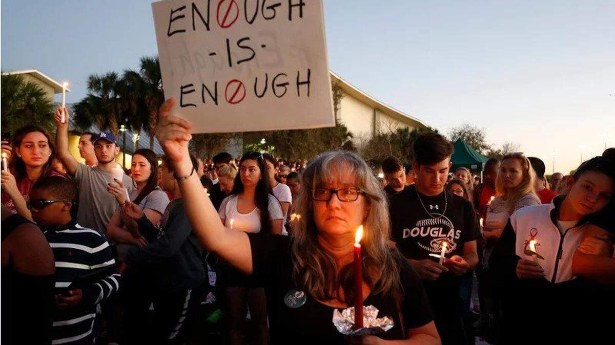 Mourners gather at a candlelight vigil for the victims of the Marjory Stoneman Douglas High School massacre the day after the Feb. 14 shooting.