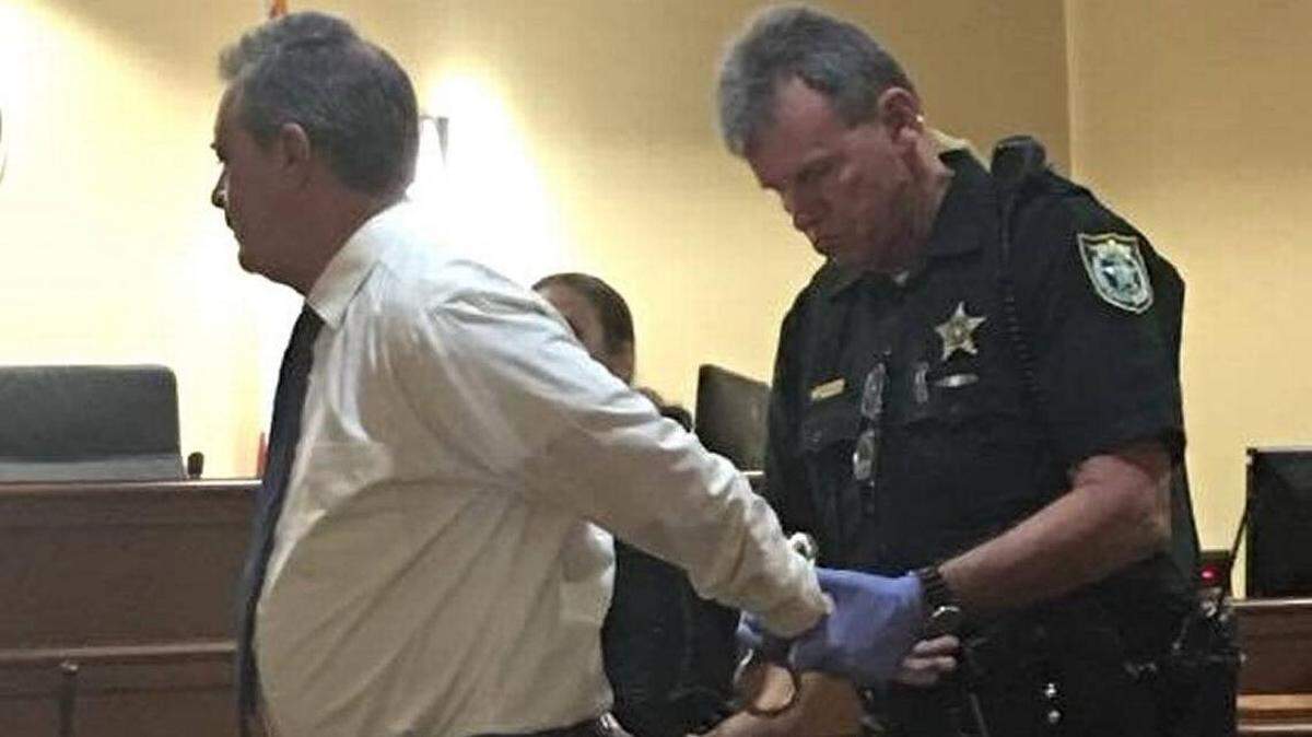 Michael Savinelli is handcuffed at the Marathon courthouse prior to being taken to the Stock Island jail May 10, 2018..