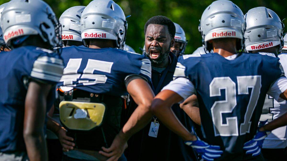 Gulliver Prep football coach Earl Sims runs drills with his team during a preseason practice at their field in Pinecrest, Florida on Monday, August 9, 2021.