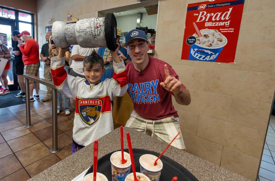 Florida Panthers center Brad Marchand poses with 9-year-old fan Alex James, who holds a homemade Stanley Cup, during a surprise visit to Dairy Queen in Sunrise, Florida, on Friday, June 20, 2025, as part of the team’s Stanley Cup victory celebration.