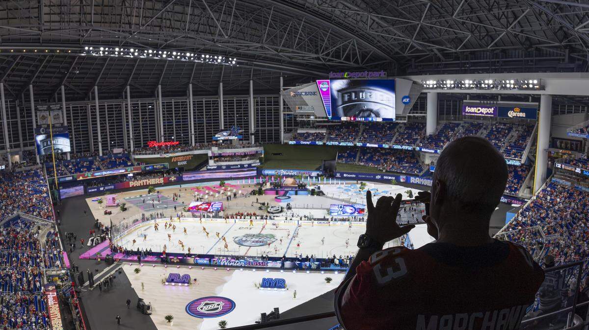 A Florida Panthers fan watches his team warm up before they play against the New York Rangers in their Winter Classic outdoor hockey game at loanDepot park on Friday, Jan. 2, 2026, in Miami, Fla.
