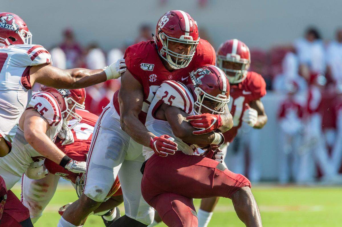 In this Sept. 7, 2019, file photo, Alabama defensive lineman Raekwon Davis (99) hits New Mexico State running back Christian Gibson (25) during the first half of an NCAA college football game in Tuscaloosa, Ala. Davis was selected by the Miami Dolphins in the second round of the NFL football draft Friday, April 24, 2020.