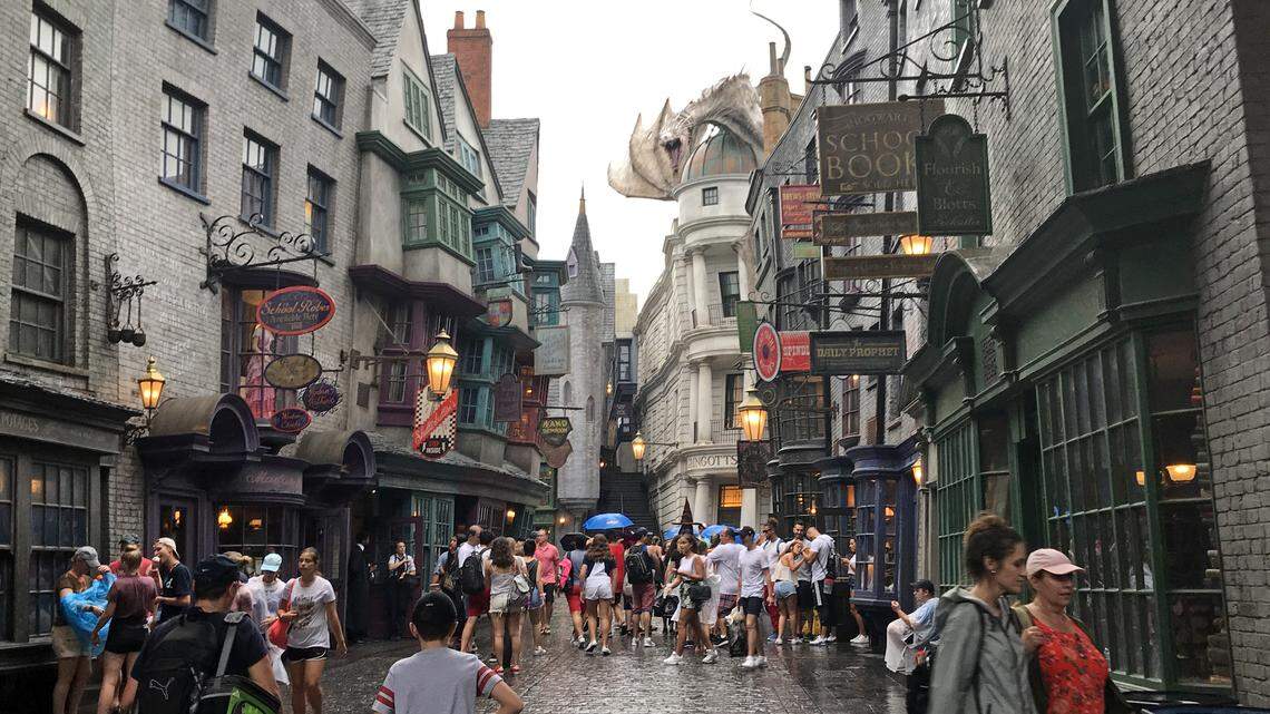 A dragon stands guard atop Gringotts bank and occasionally breathes fire on Diagon Alley in the Wizarding World of Harry Potter at Universal Studios.