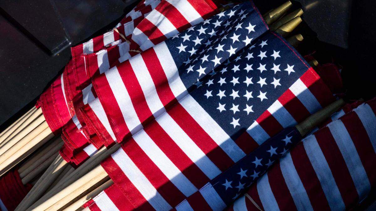 Bundles of American flags wait to be placed near headstones of fallen service members during Memorial Day weekend at South Florida National Cemetery on May 25, 2025, in Lake Worth.