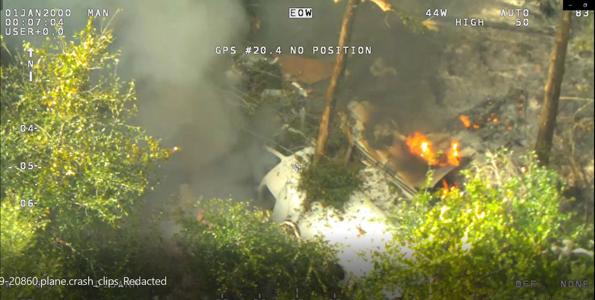 Helicopter aerial footage shows the force of the crash broke the plane in half — separating the tail from the cabin — and sparked fires near the cockpit.