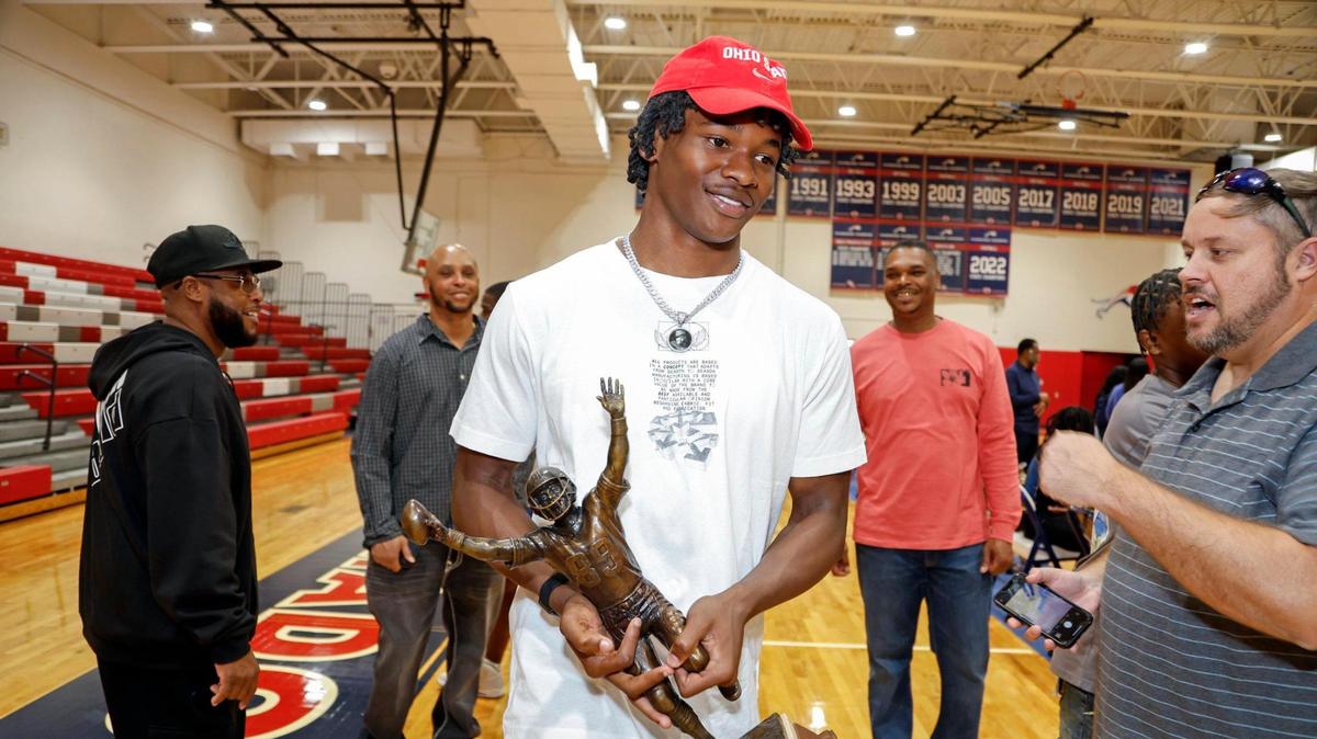 Jeremiah Smith carries his Nat Moore Trophy after committing to Ohio State, during signing day at Chaminade-Madonna in Hollywood, Florida on Wednesday, December 20, 2023.