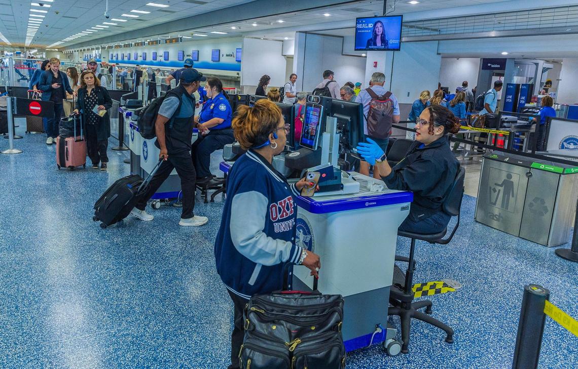 TSA agents verify passengers’ identities at a checkpoint at Miami International Airport on Wednesday, May 7, 2025.