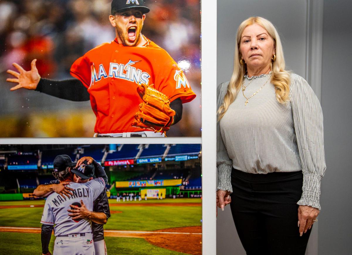 Maritza Gomez Fernandez poses next to mounted pictures of her son, Jose Fernandez, former Marlins ace pitcher and MLB All-Star, at the Fernandez residence in Miami, Florida, on Wednesday, September 15, 2021. According to the Fish & Wildlife Conservation investigation, an intoxicated Jose Fernandez was killed, along with two other men, when the boat he was piloting crashed into the Government cut north rock jetty off Miami Beach, Florida on September 25, 2016.
