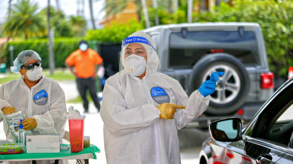Banyan Medical Systems health workers wait to test citizens at the coronavirus antibody test drive-through site at Bal Harbour Shops on Wednesday, May 13, 2020, in Bal Harbour.