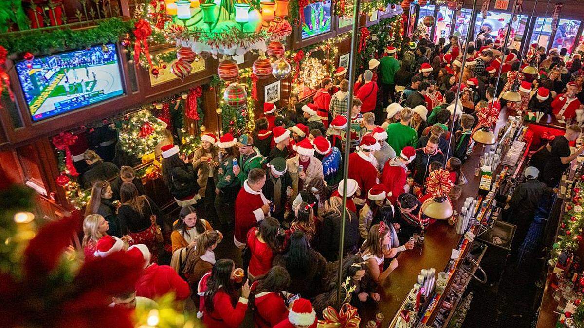 NEW YORK, NEW YORK - DECEMBER 13: Revelers gather wearing holiday character costumes in Jack Doyle's during the SantaCon bar crawl on December 13, 2025 in New York City. Attendees of the annual event gather in Midtown before dispersing to participating bars across Manhattan. (Photo by Jeremy Weine/Getty Images)