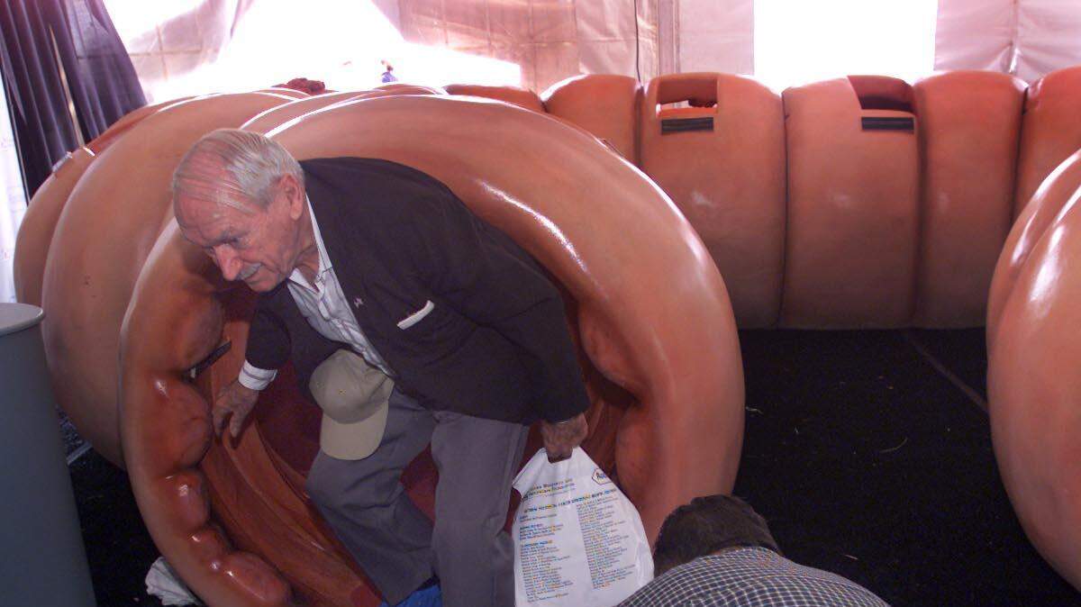 Walter Margicin of Coconut Grove climbs out of a a model of a human colon. He is a survivor of colon cancer and is attending the Colossal Colon Tour being held in Lummus Park on Miami Beach to urge people to get checked for Colorectal Cancer.