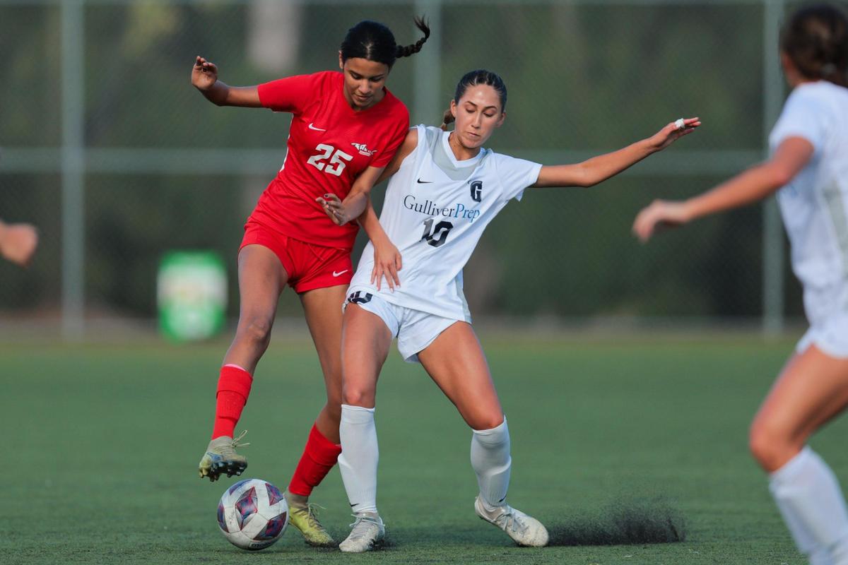 MAST Academy defender Mia Ramos (25) and Gulliver Prep midfielder Miranda De Armas (10) battle for the ball during the first half of a girls soccer playoff game at MAST Academy in Miami, Florida, Tuesday, February 11, 2025.