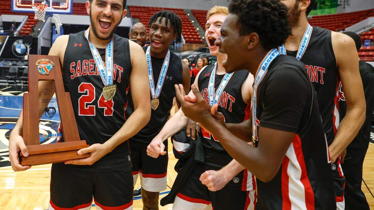 Sagemont High School’s Dominic Issa (24) holds the State Championship Trophy as he celebrates with teammates after defeating Orlando Christian Prep in the FHSAA Class 2A Final at the RP Funding Center in Lakeland, Florida on Friday, March 3, 2023.