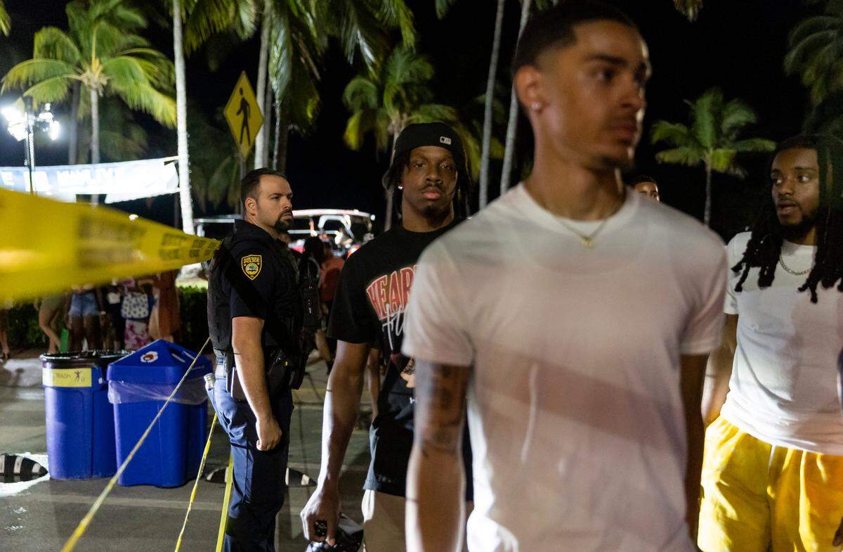 Police place caution tape to control crowds and direct traffic as people gather on Ocean Drive during spring break on Saturday, March 11, 2023, in Miami Beach, Fla.