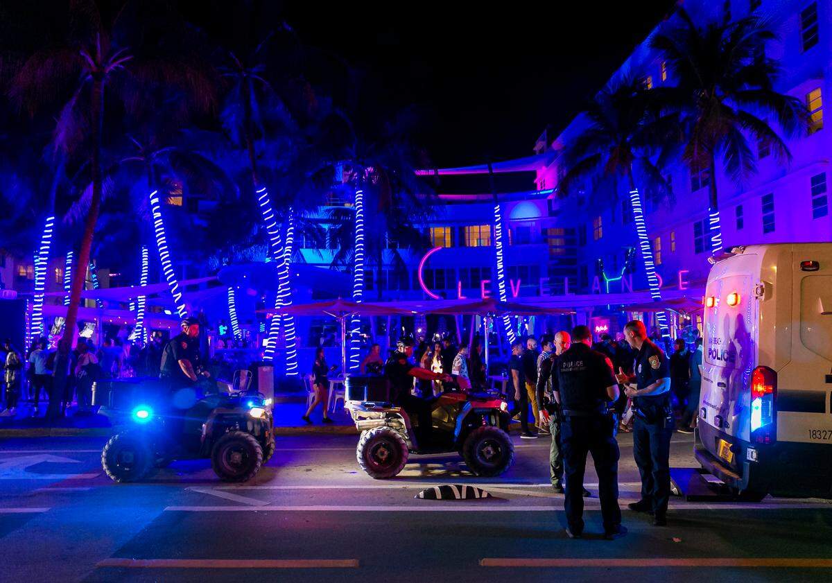 Police officers patrol near the Clevelander in Miami Beach, Florida on Friday, March 25, 2022. City officials imposed a midnight curfew and forced stores to stop selling alcohol after 6 p.m. The restrictions were set in place after two shootings in Miami Beach the weekend before caused city officials to announce a “state of emergency.”