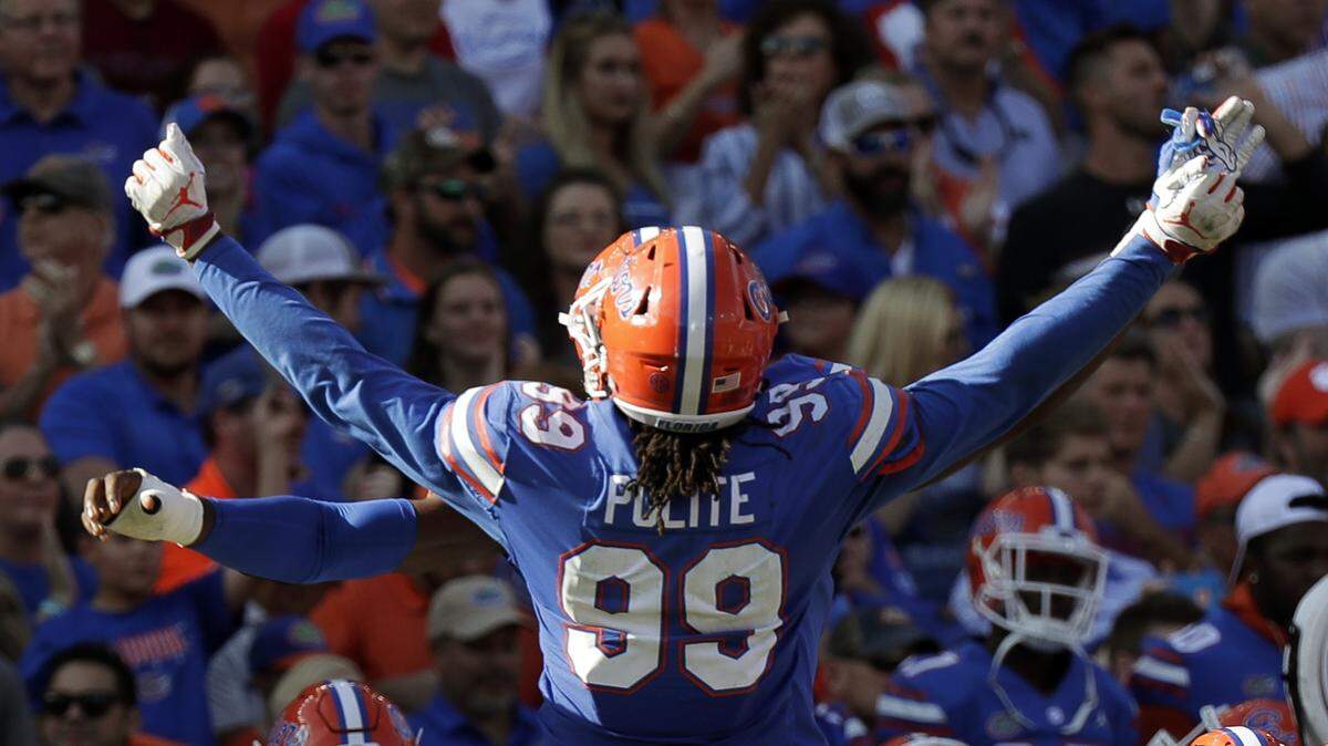 Florida defensive lineman Jachai Polite (99) does a chest bump with a teammate after stopping a South Carolina drive late in fourth quarter on Nov. 10.