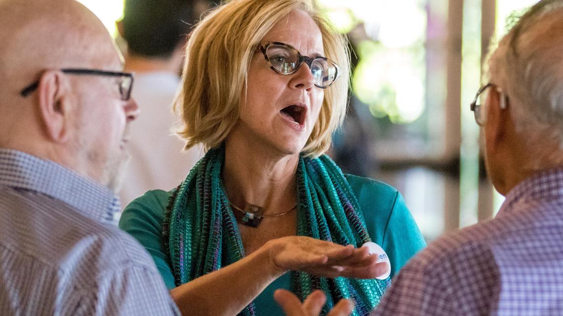Eileen Higgins, a candidate for Miami-Dade's District 5 County Commission seat, shares a moment of conversation with residents of Miami Beach during a forum at the Miami Beach Women's Club on Tuesday, May 8, 2018.