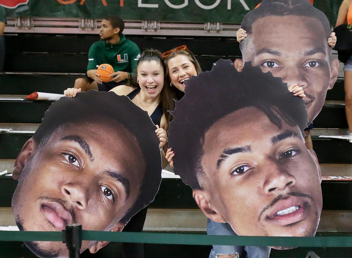 UM Hurricanes fans pose for a picture during basketball game against NC State Wolfpack on Saturday, December 10, 2022 at Watsco Center in Coral Gables. Andrew Uloza / for Miami Herald