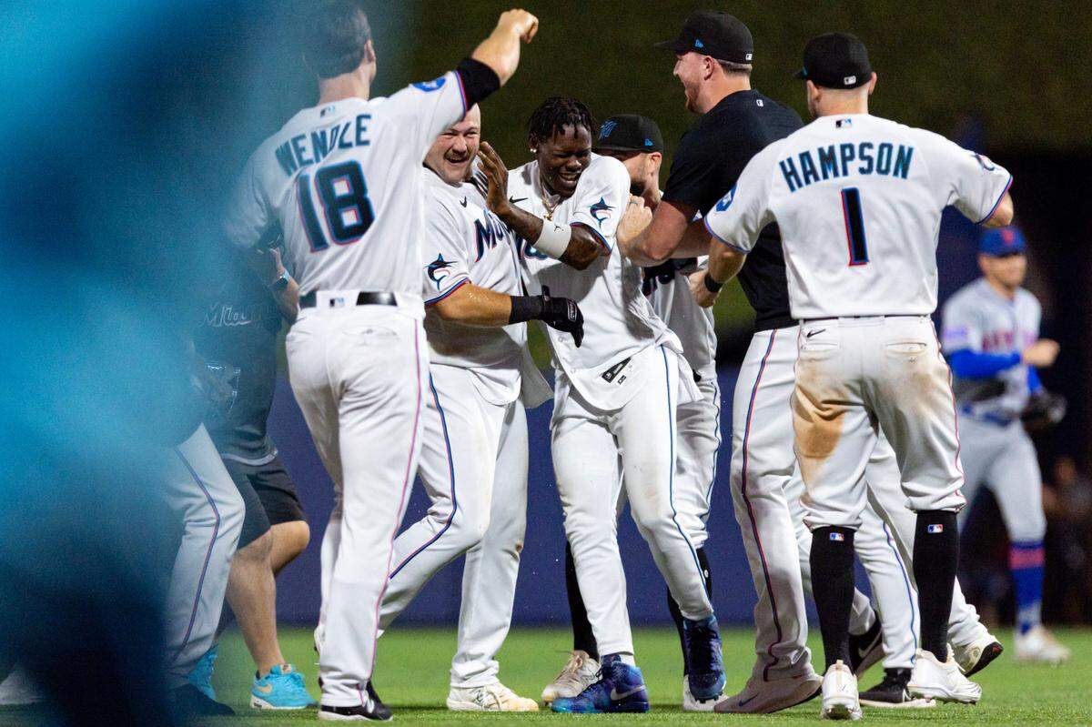 Miami Marlins third baseman Jake Burger (36) reacts with teammates after hitting a walk-off single to defeat the New York Mets 4-3 during the ninth inning of an MLB game against the New York Mets at loanDepot park in the Little Havana neighborhood of Miami, Florida, on Tuesday, September 19, 2023.
